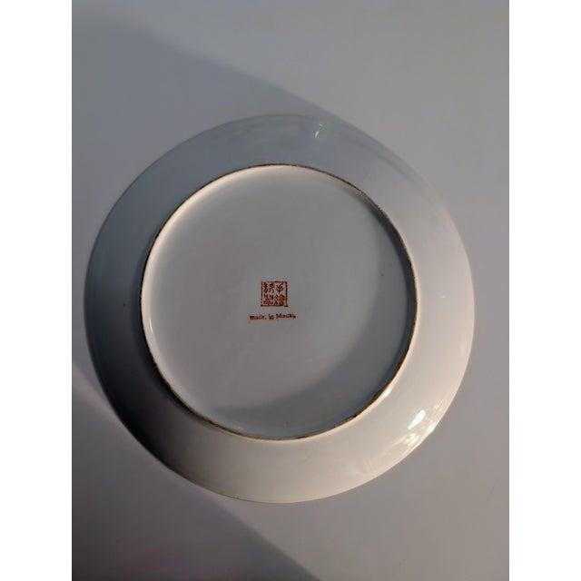 This is a mid-to-late 20th-century Chinese export porcelain decorative plate made in Macau, featuring a coral/salmon glaze...