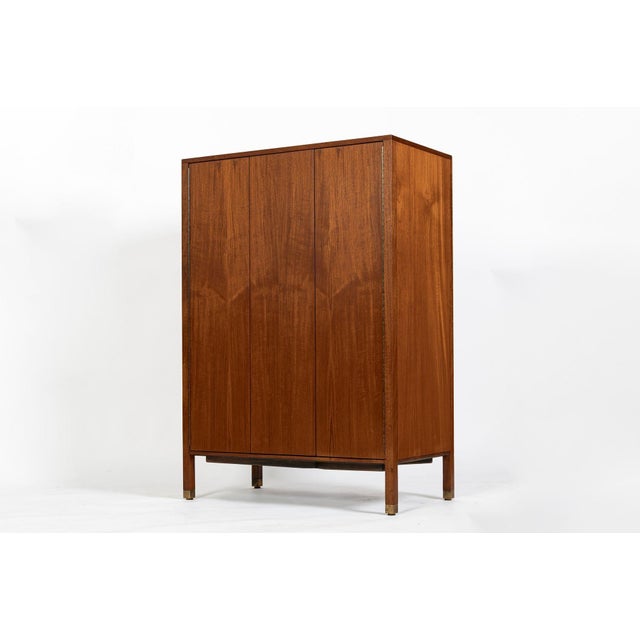 This exceptional American mid-century modern mahogany gentleman’s chest or dresser cabinet was designed by Harvey Probber...