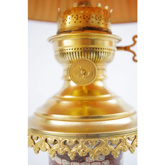 Pair of slightly bulged Satsuma earthenware lamps with a gilt bronze mount. Beige background decoration with geishas...