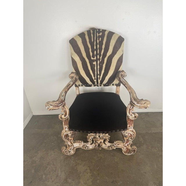 The chair has been expertly recovered in a striking combination of materials. The seat is upholstered in deep black...