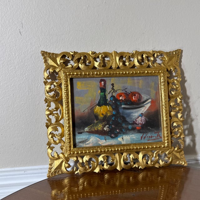 Beautiful vintage Italian still life painting featuring a classic composition of fruit, wine bottle, and table setting....