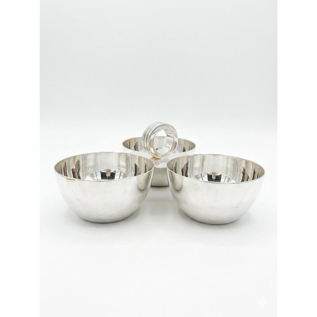 Begin your cocktail party with these silver-plated nut bowls that are connected for easy, elegant serving. Sleek lines,...