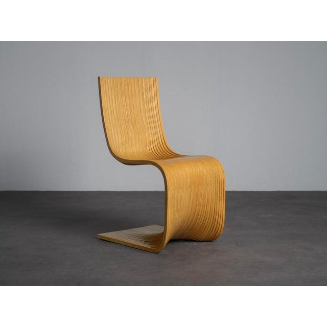 A striking pair of contour chairs designed by alejandro estrada for piegatto in 2006. Crafted from laminated bamboo, the...