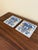 A classic pair of Dutch Delft-style hand painted blue and white porcelain tiles featuring an intricately rendered heraldic...