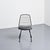 Set of four black lacquered metal chairs with openwork backs by Jean-Louis Bonnant. These chairs are famous for having...