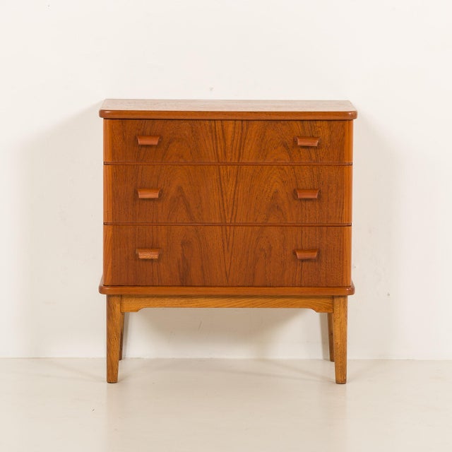 This small Danish teak dresser comes from the 1960s. It represents a classic mid-century modern design. Overall size is H:...