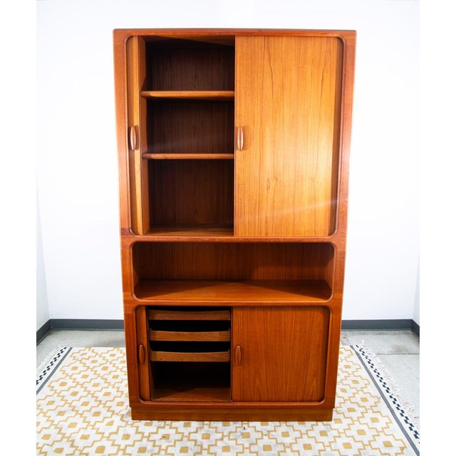 This exceptional tall cabinet by Dyrlund is a masterclass in Danish Modern functionalism and organic design. Crafted from...