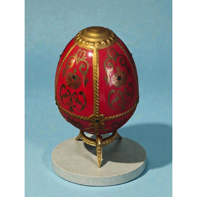 The Franklin Mint House of Faberge Imperial Porcelain Red Gilded Jeweled Egg is a stunning decorative collectible piece...