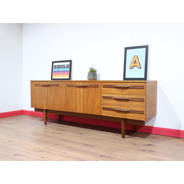 This Mid Century Modern Vintage Teak Sideboard Credenza in the style of Stonehill is a fabulous example of a mid century...