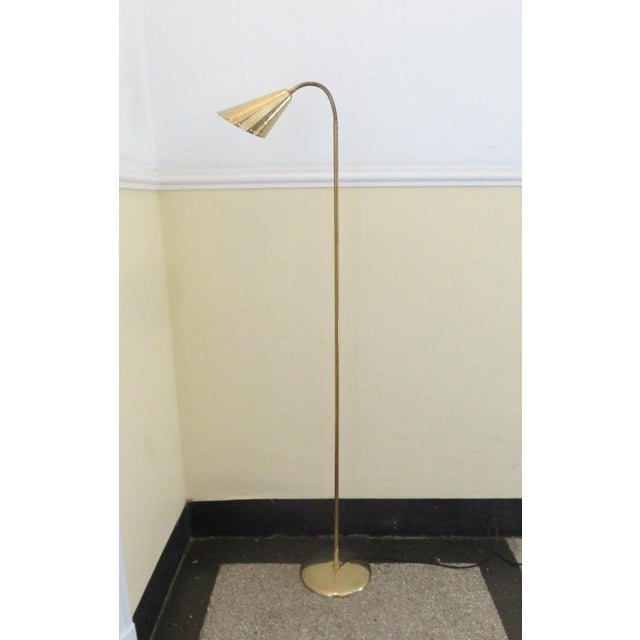 A delicate and elegant floor lamp from Scandinavia, made in the 50s in the style of Paavo Tynell. The base, arm and shade...