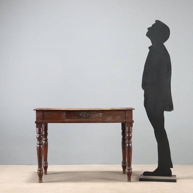 Italian-made walnut writing desk dating back to the late 19th century, featuring a classic and functional design. The...