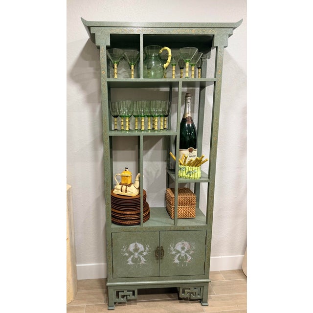 A fantastic Pagoda style display in a light green or sage color with hand painted details white and gold. Beautiful...
