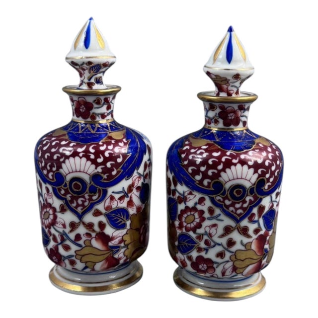 A decorative pair of porcelain perfume bottles from the Dresden circle, dating to around 1890–1910 and painted in the...