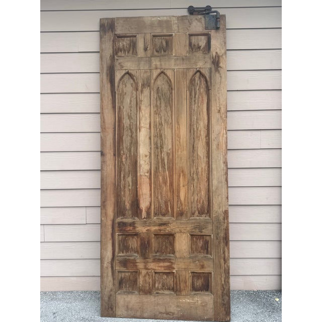 A striking 19th-century Gothic solid-wood door, salvaged from an early American structure and retaining its incredible...