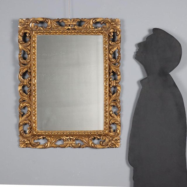 Carved and gilded wood and pastiglia mirror. Frame pierced and carved with scrolls and curls. Missing parts. Italy, 20th...