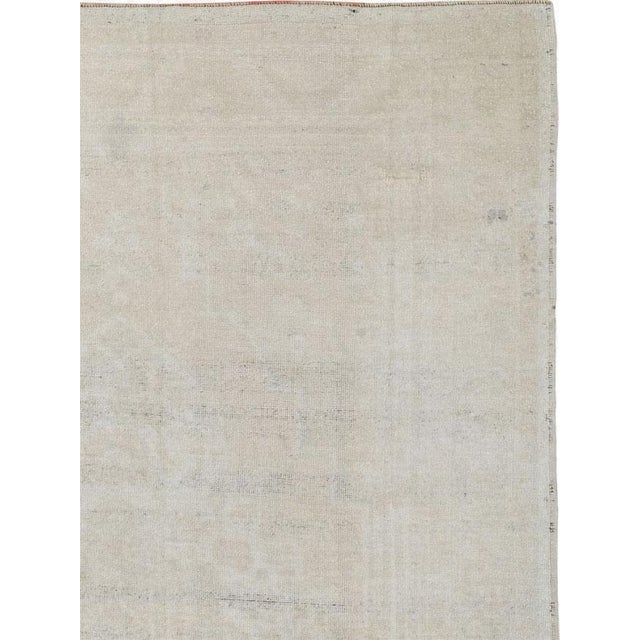 This mid-20th-century Turkish Anatolian gallery carpet presents a restrained, near-monochromatic composition in soft...