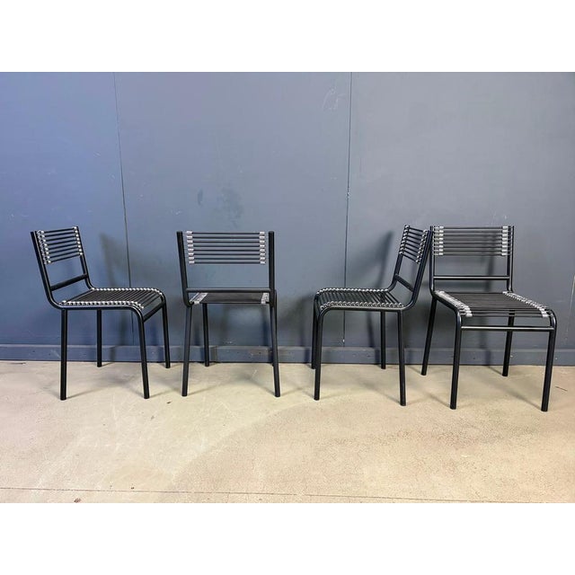 Vintage black metal dining chairs with elastic cords designed by rene Herbst in the bauhaus period and produced in the...
