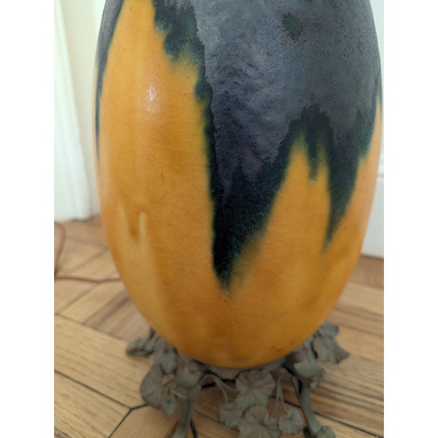 Louis Dage table lamp from France. Art Deco ceramics with metal work of fauna. Bottom signed. No finial