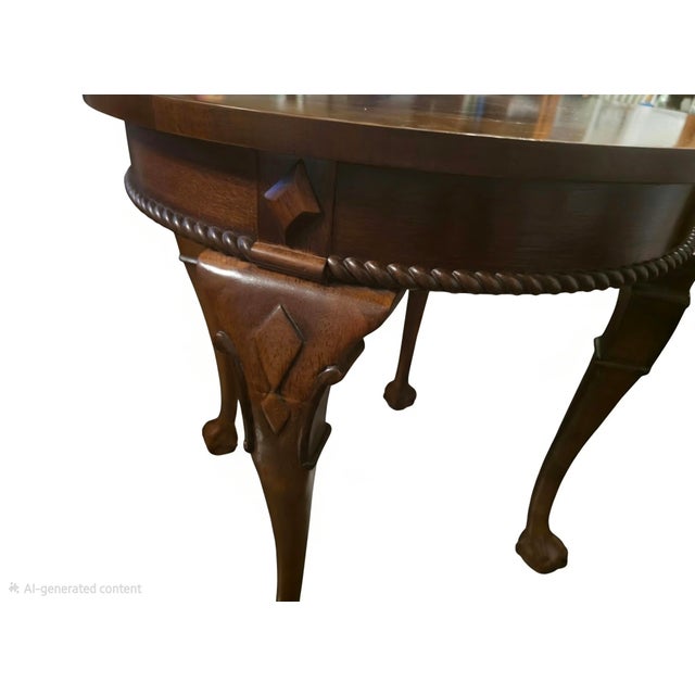 Beautiful 20th-century round accent table in mahogany. Features a striking, high-quality sunburst wood veneer inlay...