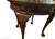 Beautiful 20th-century round accent table in mahogany. Features a striking, high-quality sunburst wood veneer inlay...