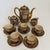 An ornate Japanese Satsuma demitasse service by Shuzan, dating to the Meiji period (1868–1912). Each piece is densely...