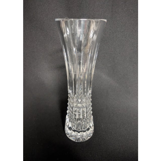 A tall Waterford Lismore crystal bud vase. The Lismore diamond vase has a thick flared top paired with a nicely weighted...