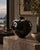 A striking oversized studio pottery vase featuring a sculptural rounded form, deep glossy black glaze, and bold white...