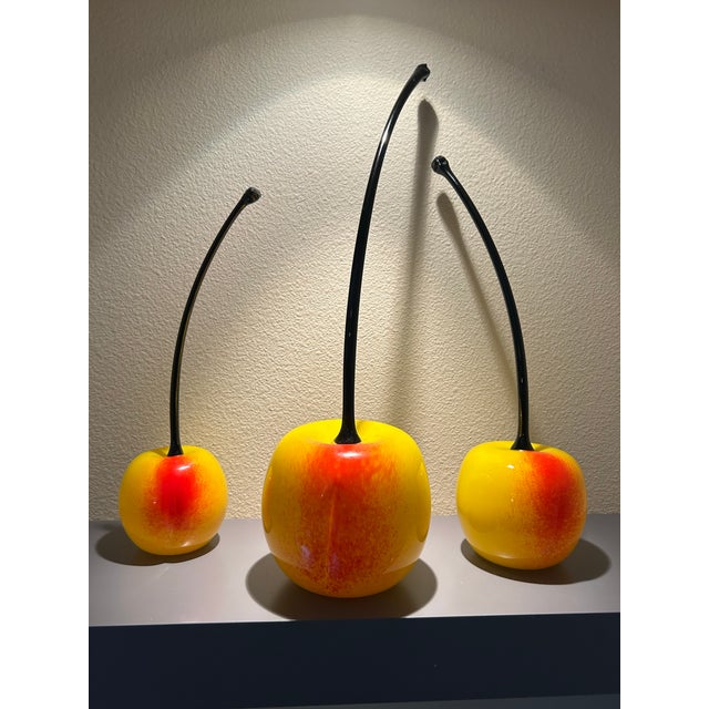Oversized studio art glass Cherry sculpture trio, purchased from a Laguna Beach gallery circa 2005-2007. Vibrant colors,...
