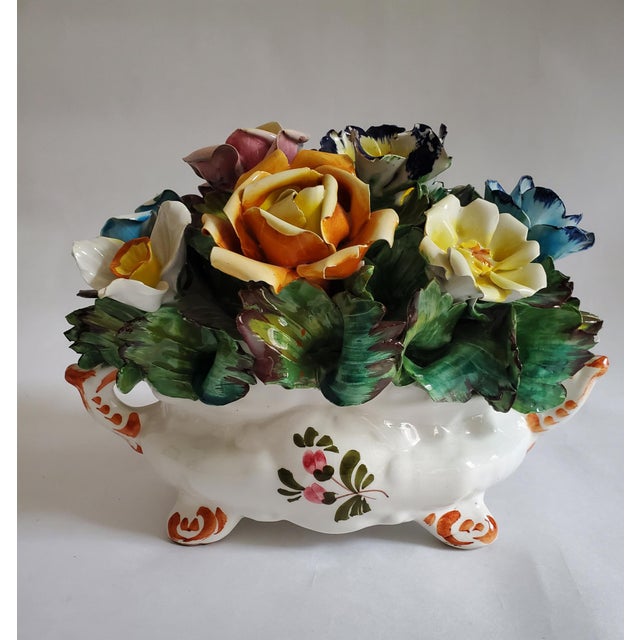 This exquisite Capodimonte-style ceramic floral centerpiece showcases the artistry of mid-century Italian porcelain....