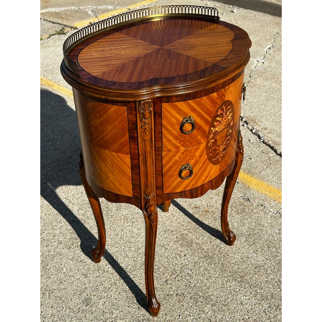 Immaculate 1940’s marquetry Louis XV inlaid nightstand. Two dovetailed drawers with garland brass hardware, Cabriole legs,...