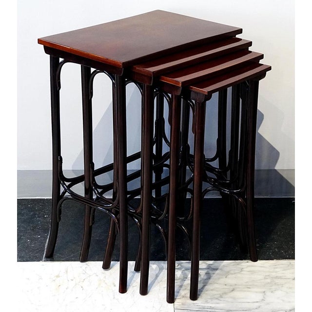 An elegant Art Nouveau side table set comprising four individual tables of varying sizes that can be nested inside one...