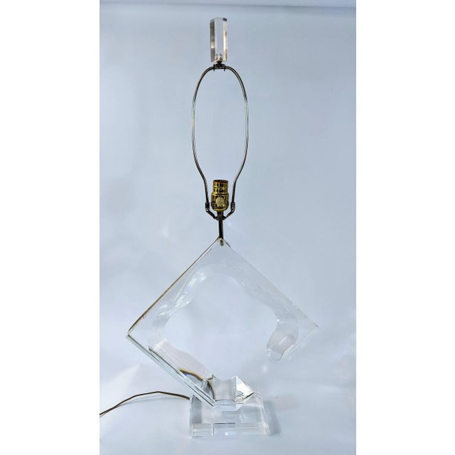 Lovely abstract Lucite lamp signed Van Teal. The form of the lamp is such that when certain light hits it, it gives off a...