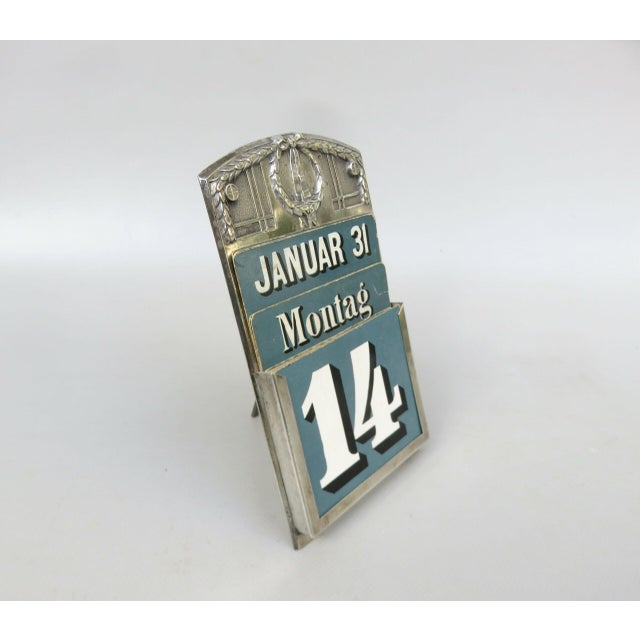 A rare and exceptional perpetual calendar from the Art Nouveau period, featuring all original blue cardboard cards in a...