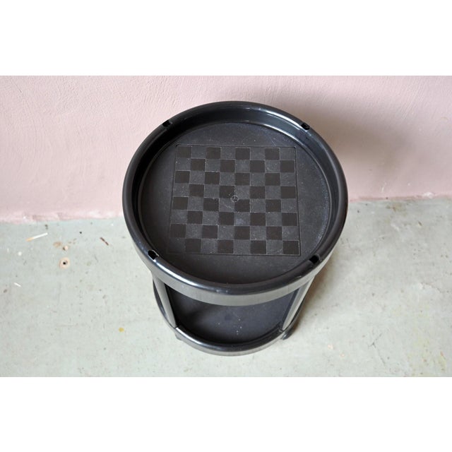 A piece of Italian domestic design from the 1980s, this small rolling serving cart is a fun addition. Made of black...