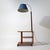 An Italian floor lamp from the 1930s combining lighting, side table, and small shelving unit into a single piece,...