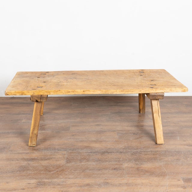 The appeal of this rustic coffee table comes from the thick wood of the top that originally served as a worktable, all...