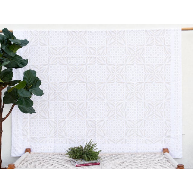 A lightweight cotton coverlet from Western India, beautifully adorned with intricate handcrafted appliqué cutwork. The...