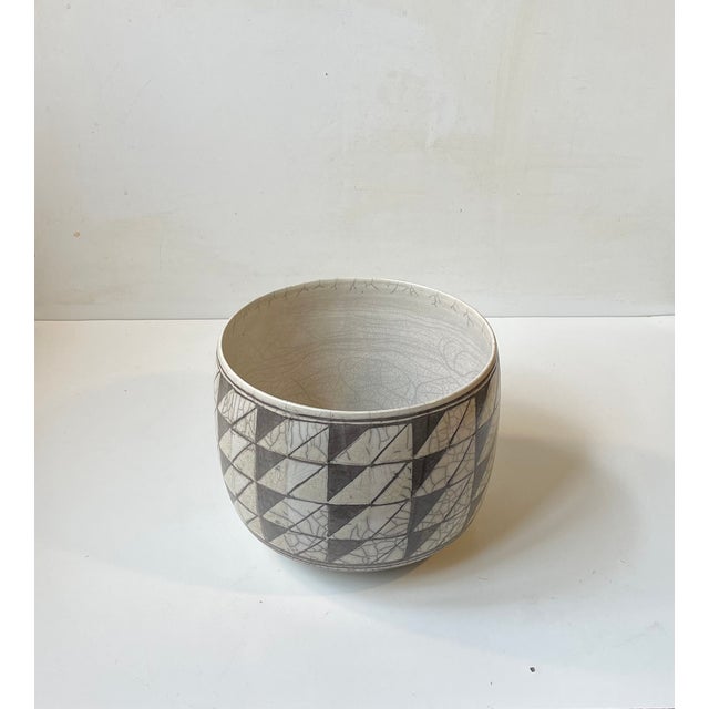 A stylish centerpiece bowl or elegant planter in Raku glazed stoneware. Executed with a hand-glazed geometric pattern....