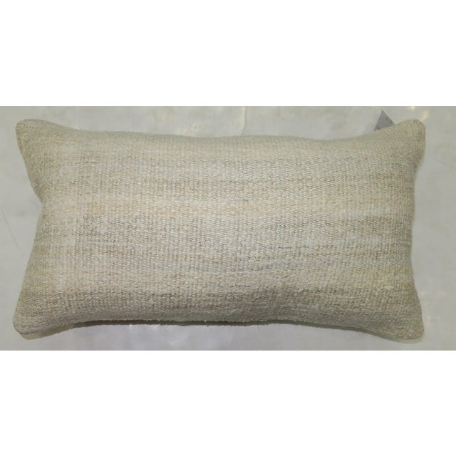 Pillow made from modern Turkish Kilim in white. Measures: 11" x 22".
