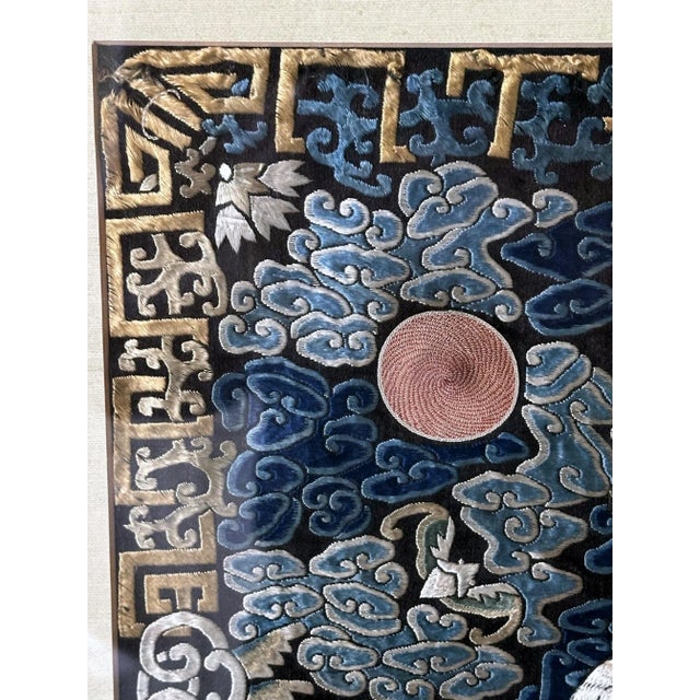 A finely embroidered silk civil rank badge panel framed in a giltwood frame circa 19th century. The square rank badge is...