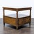 This wooden end table features a classic design with two front doors that open to reveal a spacious storage cabinet. It...