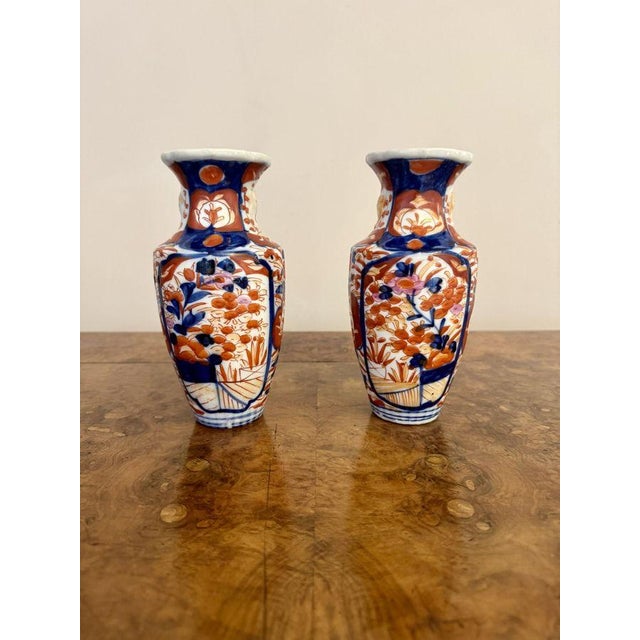 Quality pair of small antique Japanese imari vases, having a quality pair of antique Japanese imari vases, with bulbous...