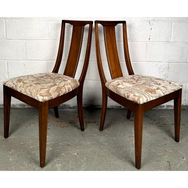 Elevate your dining space with this beautifully crafted mid-century dining chair set, complete with a stately captain’s...