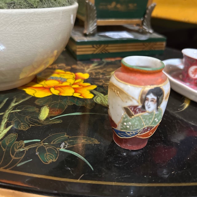 Up for consideration is a beautiful vintage miniature Asian vase with a woman and fan design. This would look lovely in...