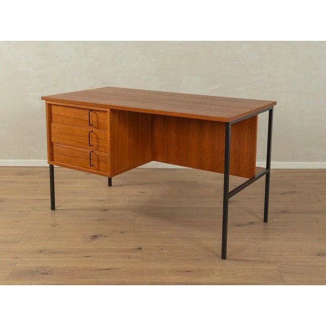 Minimalist freestanding desk from the 1960s by Günter Renkel for Rego Möbel. Teak veneer body with three drawers, a...