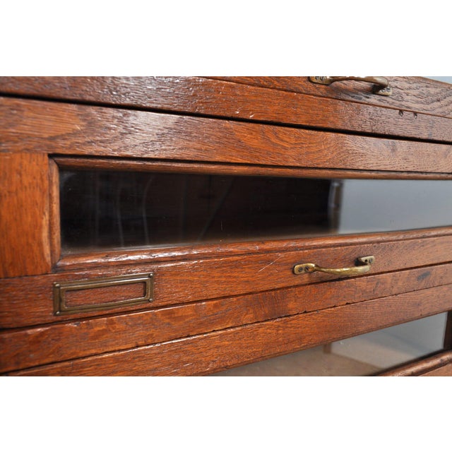 One of a kind! a beautiful oak chest of drawers with glass fronts. The brass fittings are still complete. The left row of...