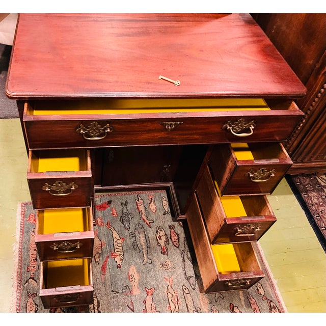 Victorian walnut kneehole desk with key. Original period brass hardware, re-entrant corners act as the drawer pull for a...