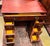 Victorian walnut kneehole desk with key. Original period brass hardware, re-entrant corners act as the drawer pull for a...