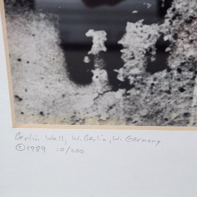 Striking 1989 limited-edition photographic print depicting figures along the Berlin Wall in West Berlin, West Germany, by...