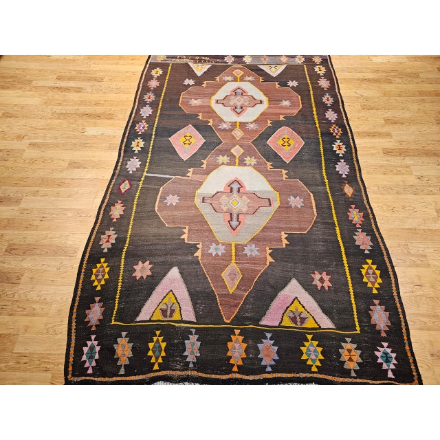 A masterwork of mid-century Turkish flatweave design, this vintage kilim from the third quarter of the 20th century offers...